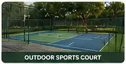 Outdoor sports court bordered by residential landscape